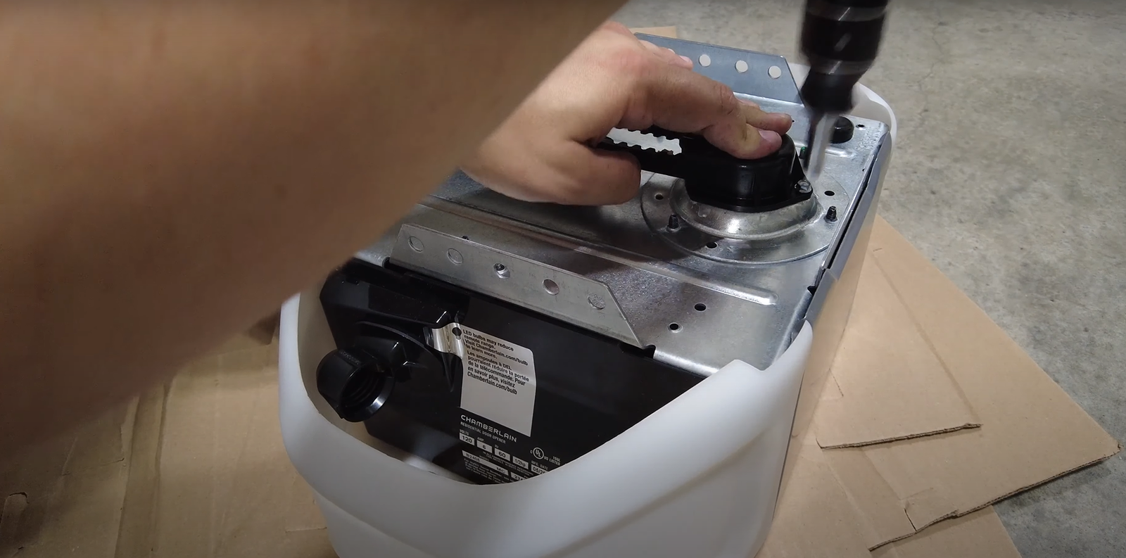 A garage door opener getting repair by experts.