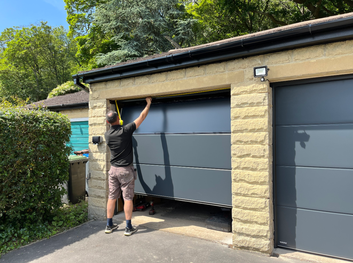 A expert technician doing garage door section replacement in Reynoldsburg, OH.