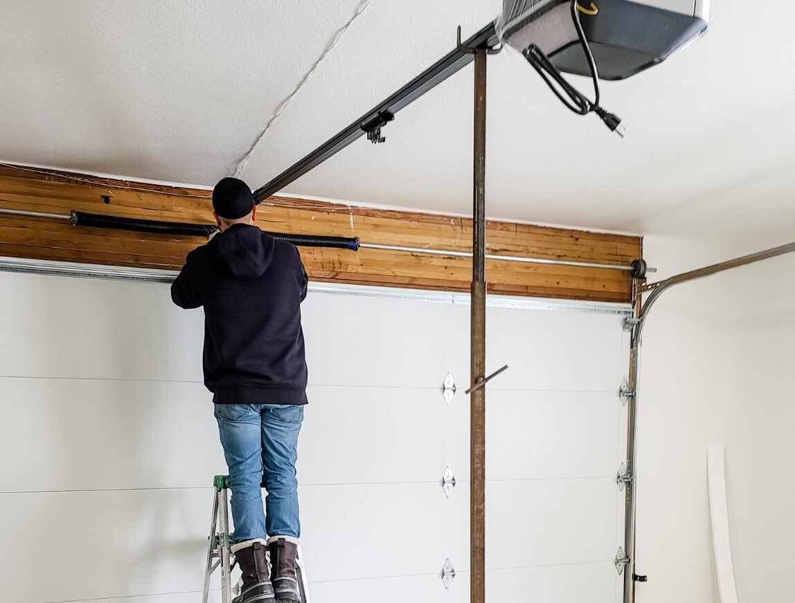 Close-up image of a technician performing garage door spring repair in Reynoldsburg, ensuring optimal functionality and safety.