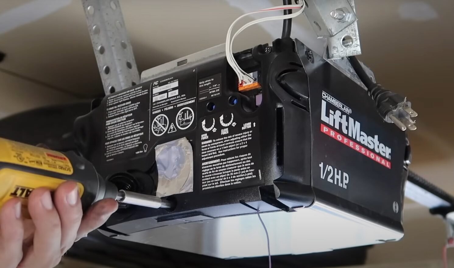 Professional technician performing garage door opener repair in Reynoldsburg